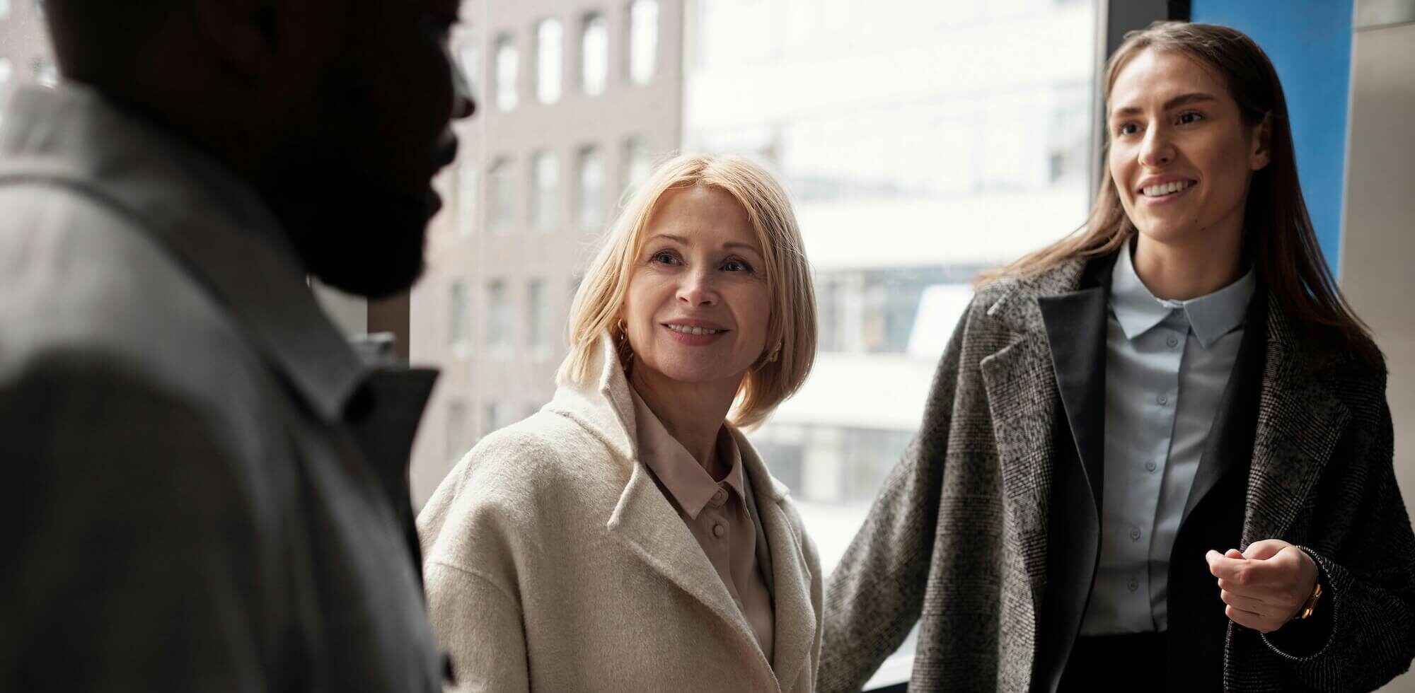 Three people standing together.